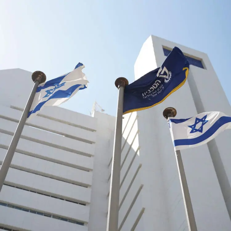 israeli flag and technion flag flying in front of rappaport building in haifa, israel | Donate to Support Israel | Technion University | American Technion Society