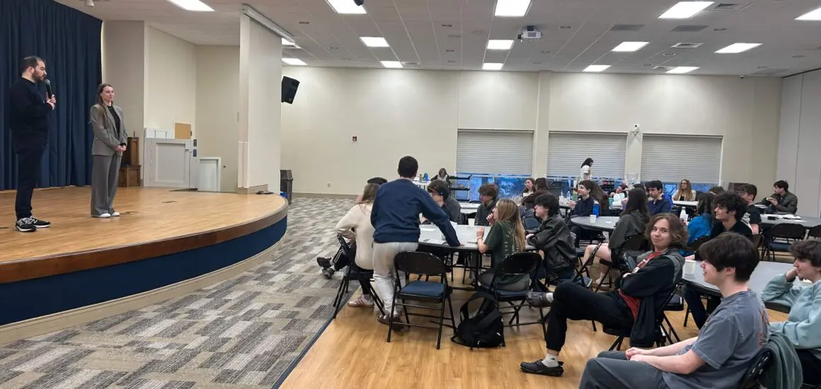 Students sitting in an auditorium for a presentation