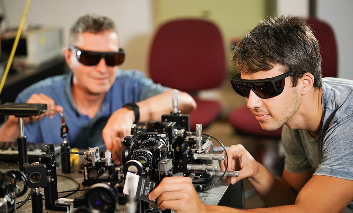Technion researchers in a lab with protective glasses, working with lasers on quantum metamaterials | Donate to Support the Technion University | How to Support Israel
