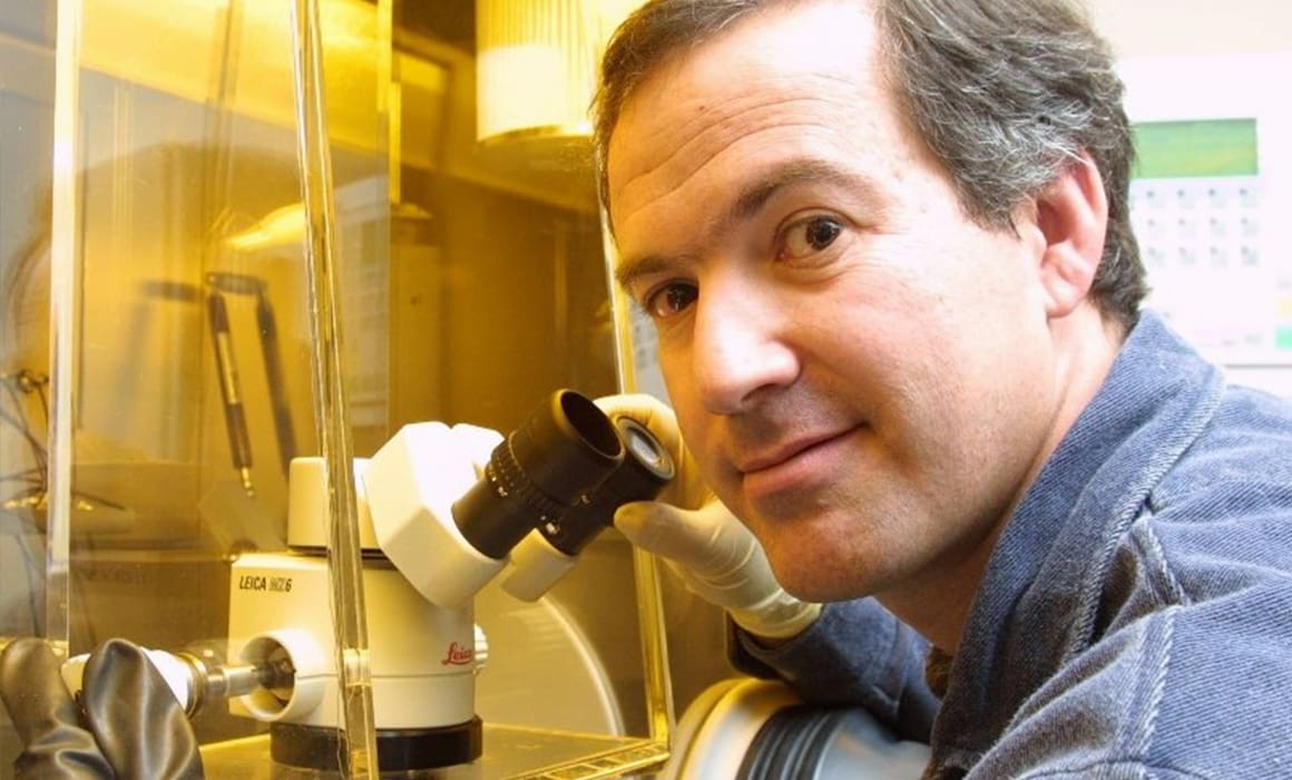 Technion professor in lab with microscope looking at solar cells looking directly into the camera | Donate to Support Israel | American Technion Society