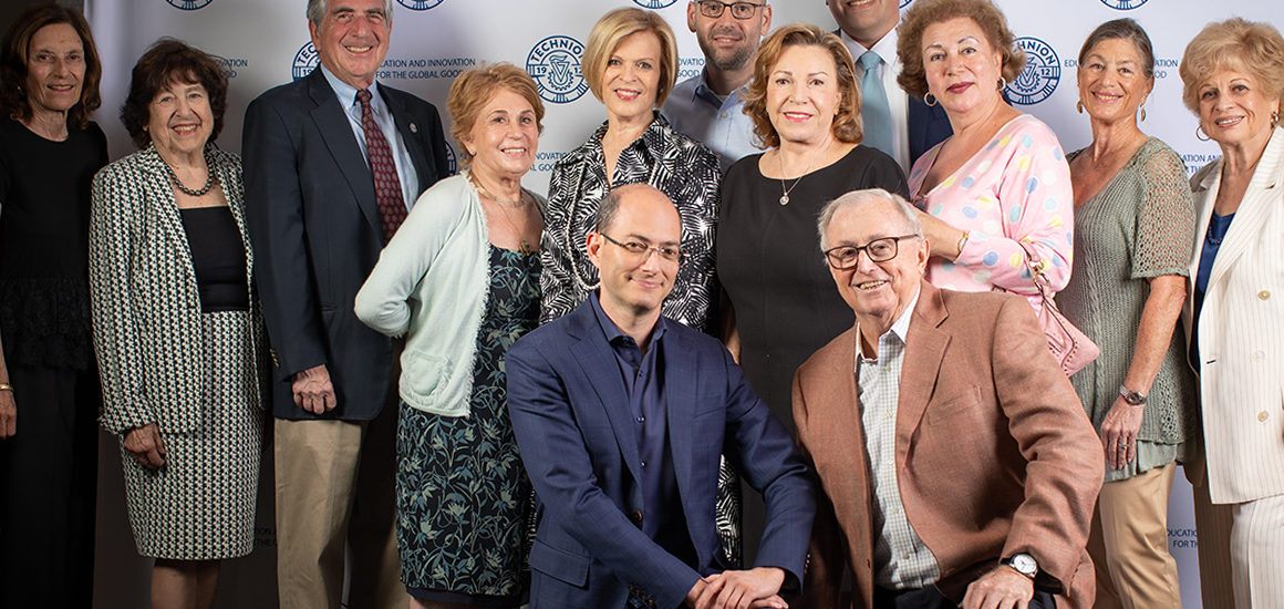 American Technion Society supporters and board members posing in front of a step-and-repeat during an event with Technion Professor Itamar Kahn in California.