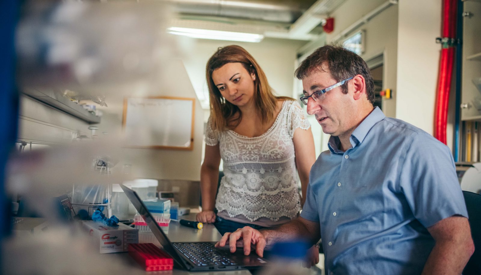Professor Shai Shen-Orr with a student looking at a laptop in a Technion lab.