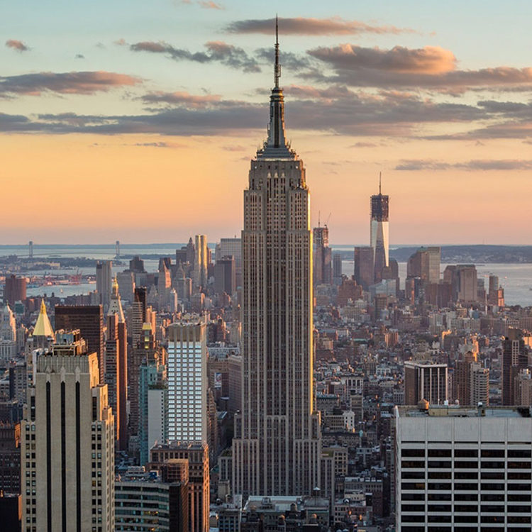 The Empire State Building and Manhattan skyline at sunset.