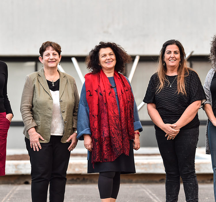 Women of the Technion posing outside of a campus building in Haifa.