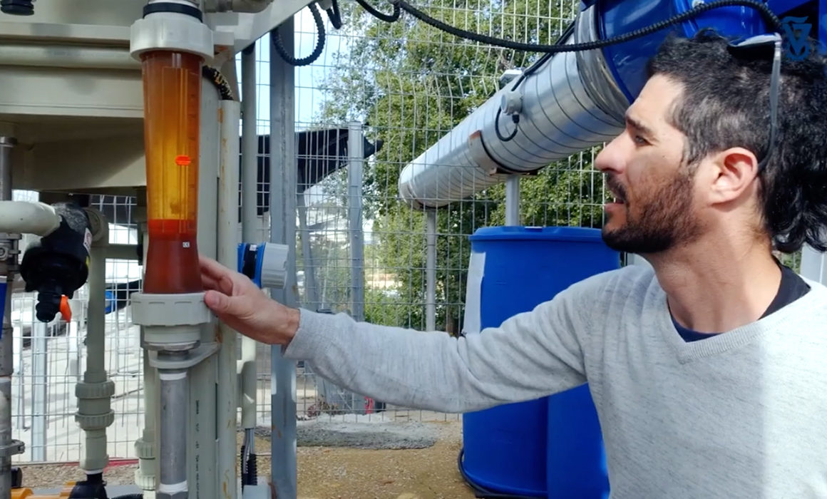 Technion researcher examining a machine used to produce water from air.