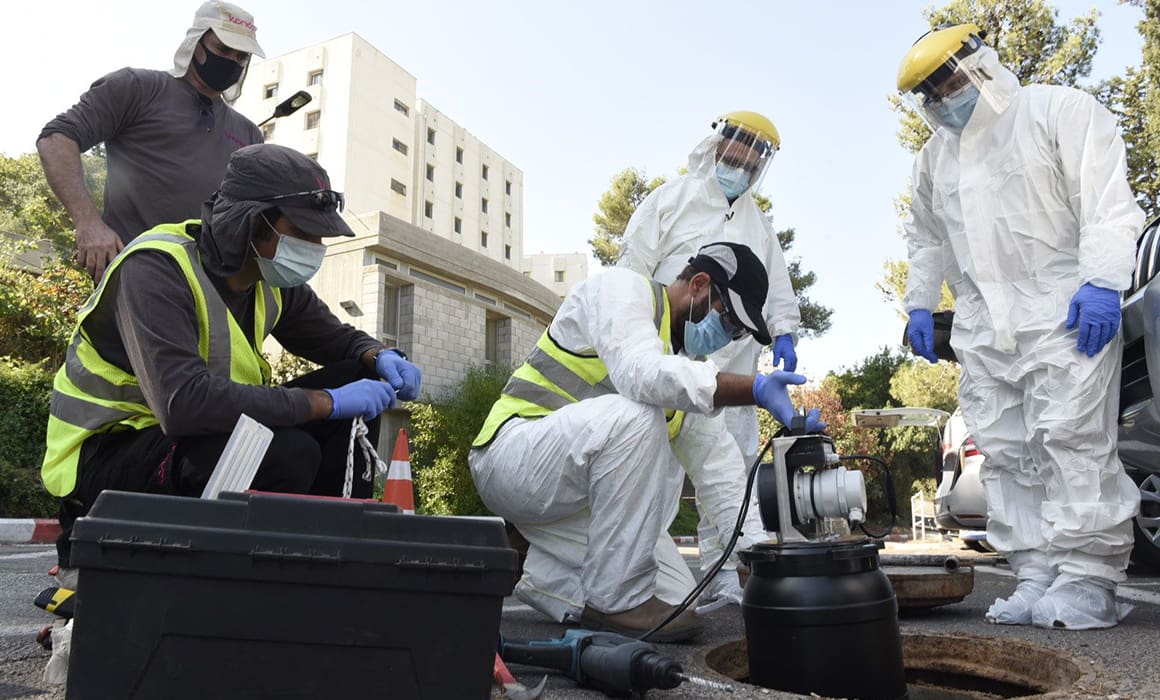 medical professionals studying wastewater wearing ppe detecting COVID-19 virus in real time out in the field | Donate to Support Israel | Technion University