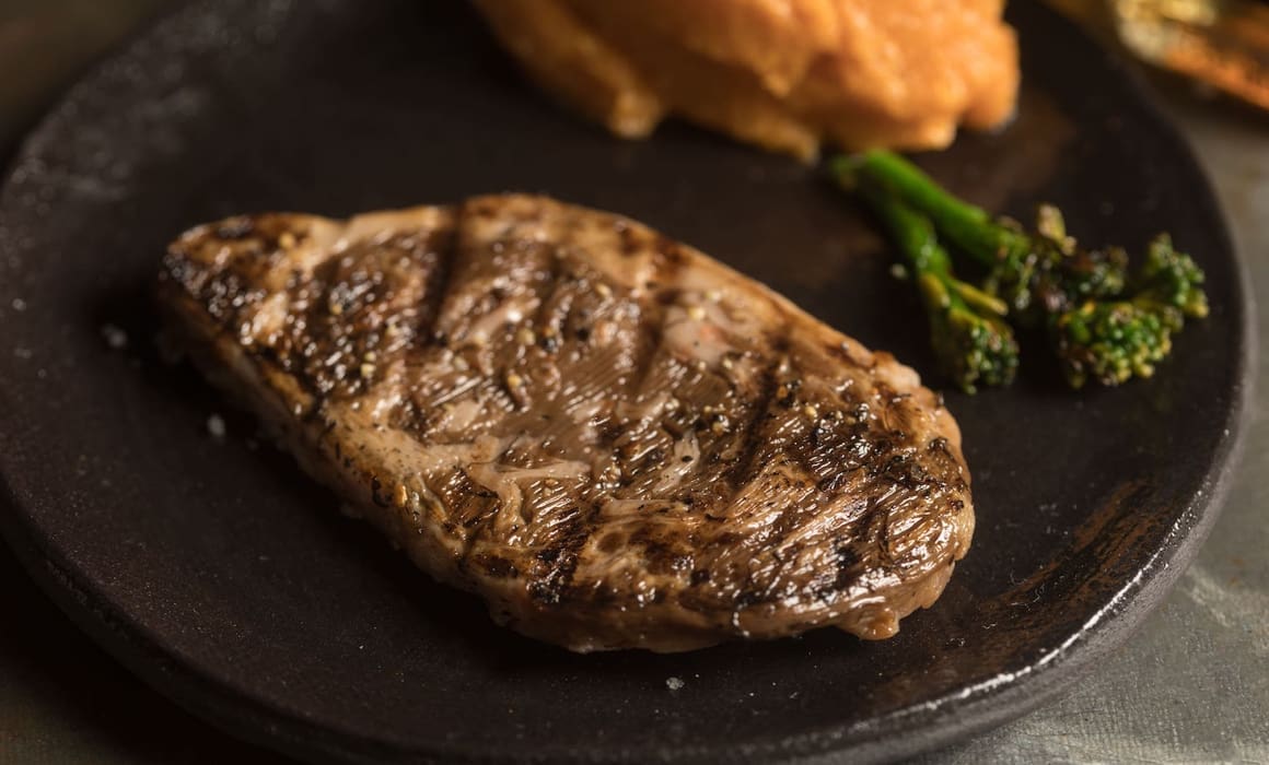 meat free steak from aleph farms on a black plate with broccolini | Donate to Support Israel | Technion University