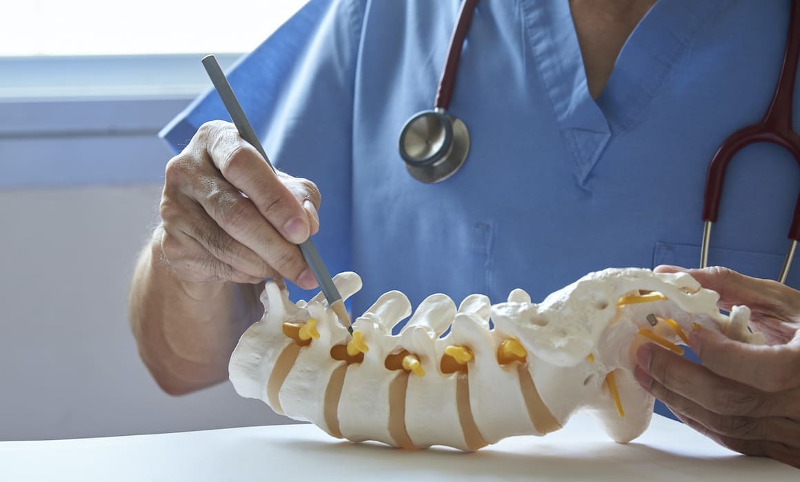 bone surgery on spine by doctor in blue scrubs with stethoscope | Donate to Support Israel | Technion University