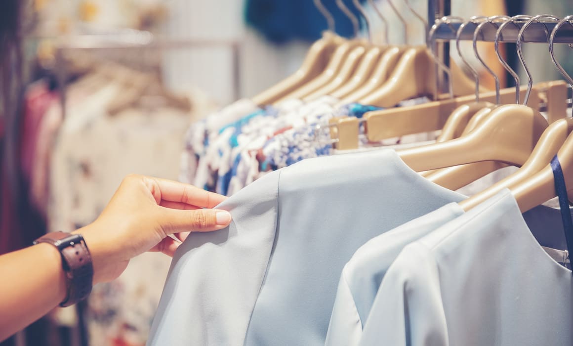 woman's hand browsing clothing on a rack in walmart | Donate to Support Israel | Technion University