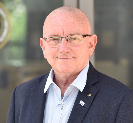 Headshot of a man with glasses in front of logoed door | American Technion Society | Technion