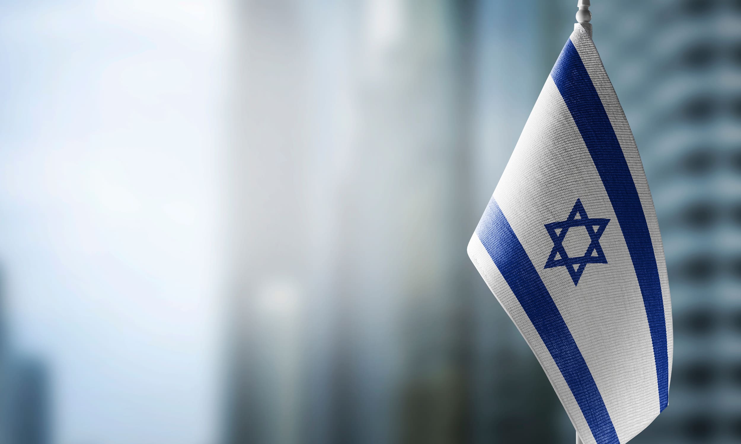 to be israeli | israeli flag in window of office building | Donate to Support Israel | How to Support Technion University