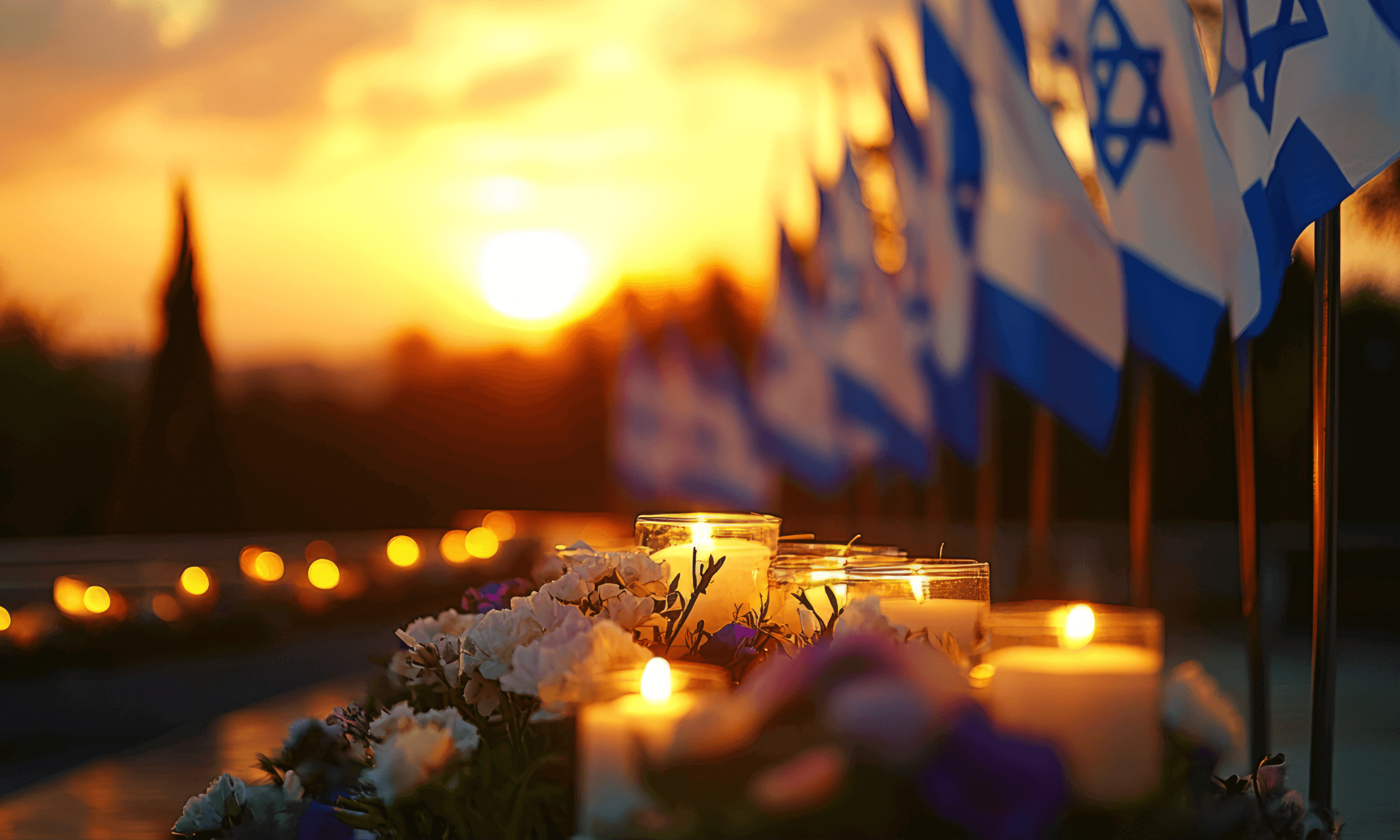 Israel flags lined up along yahrzeit candles in honor of october 7