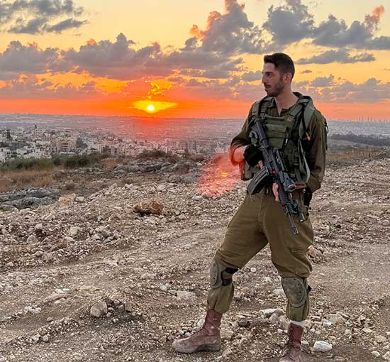 Soldier standing in front of a sunset