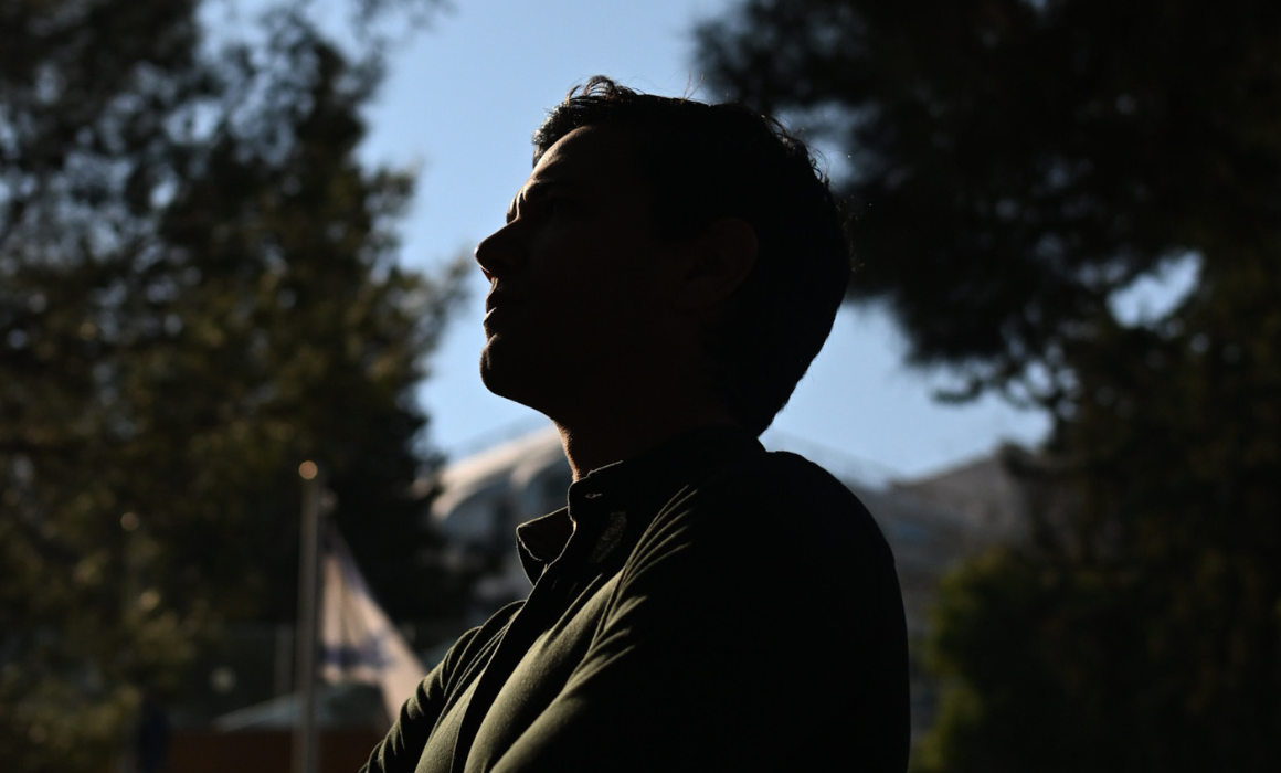 Student standing outside looking heroic.