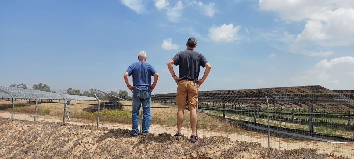 two men standing on dirt facing a green field with blue sky and clouds | Donate to Support the Technion University | Israel | American Technion Society
