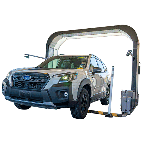 Subaru Forester emerging through rectangular structure on white background.