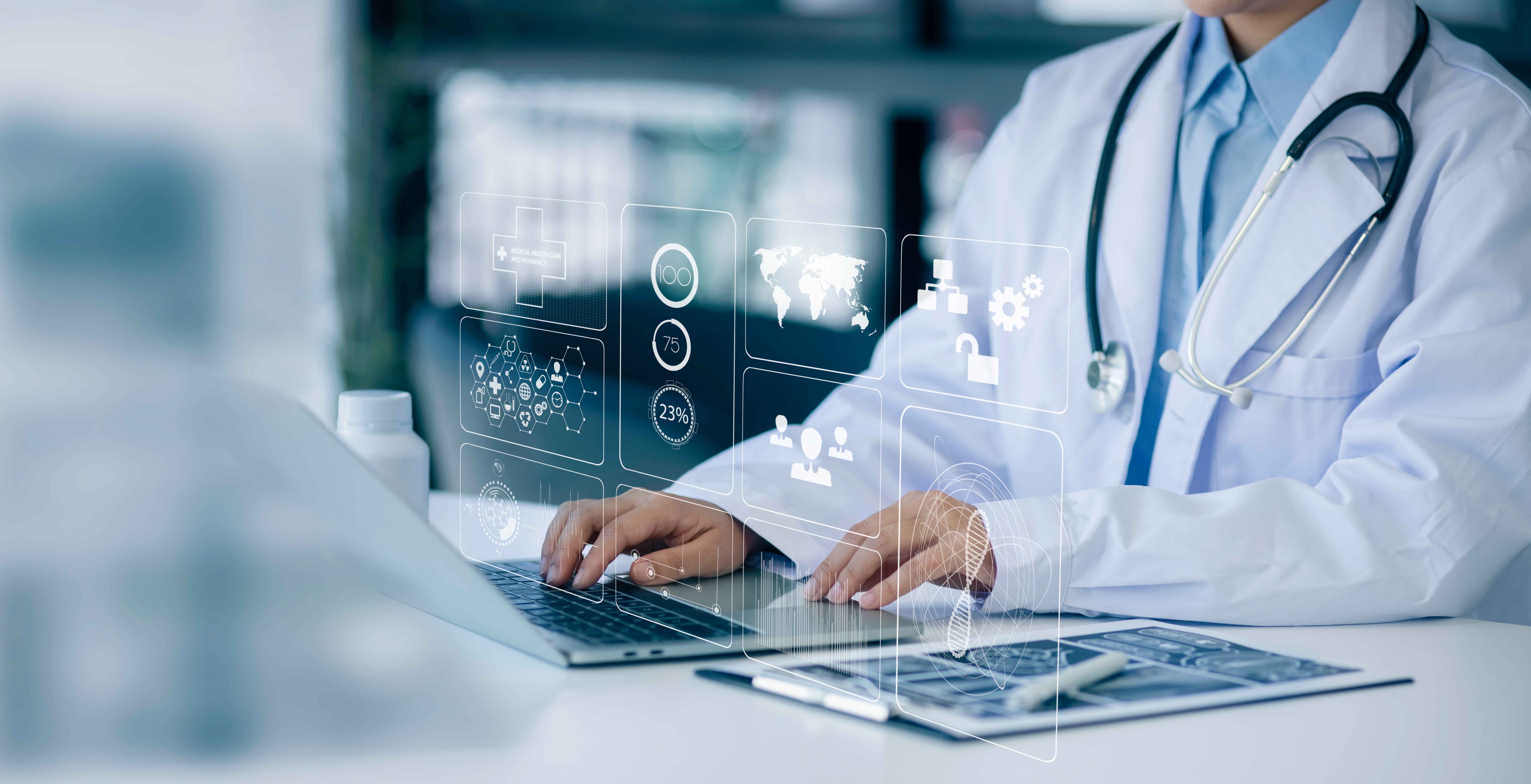 Laptop on desk in lab setting. Hands protrude from white lab coat on laptop. High tech hologram emits from laptop.