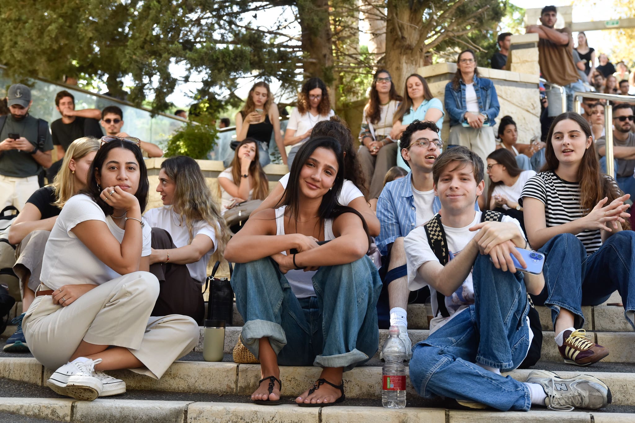 Technion students sit on ampitheater steps with more students in background